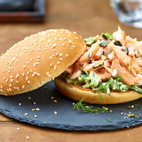 Ölz Maxi Burger Brötle mit „Pulled Lachs“, Schafkäse, Romanasalat, Rahmgurken & gerösteten Kürbiskernen Ölz Maxi Burger Brötle mit „Pulled Lachs“, Schafkäse, Romanasalat, Rahmgurken & gerösteten Kürbiskernen